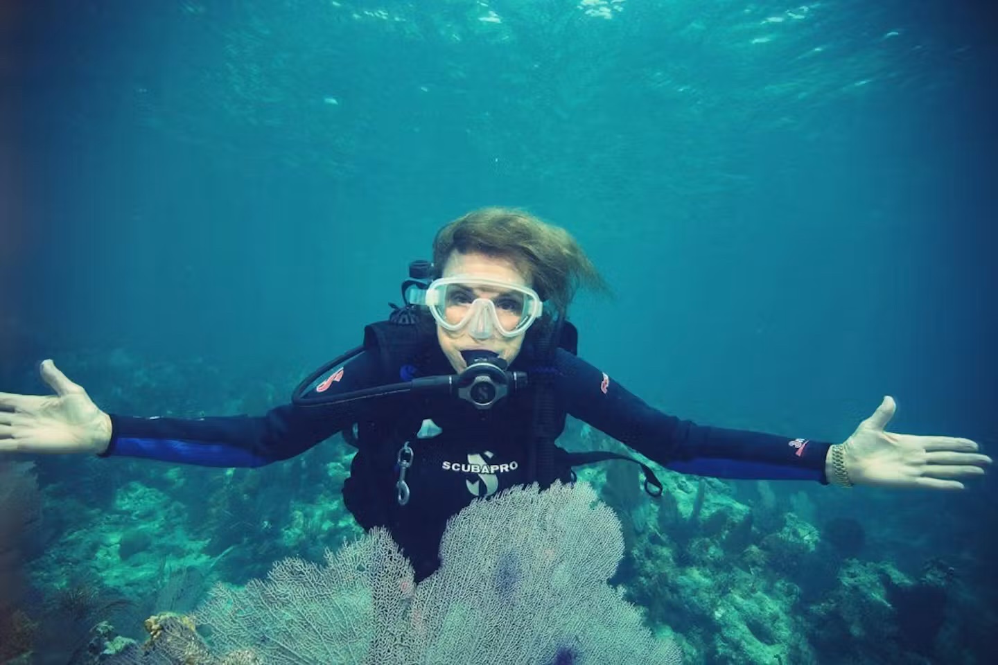 Sylvia Earle scuba diving over a coral reef in Lasting Hope